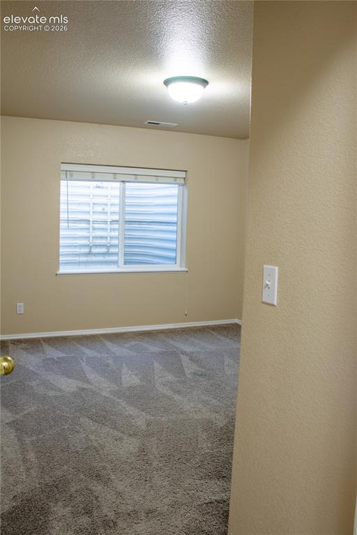 Image 25 of 40: Interior room featuring neutral wall paint, a single window with blinds, an