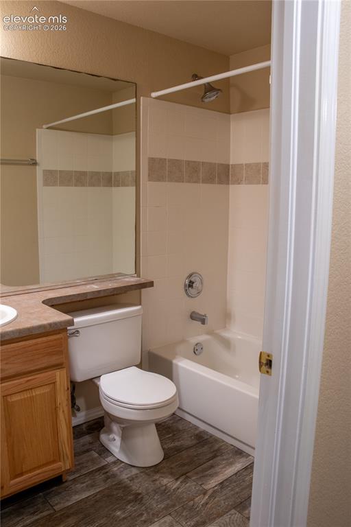 Image 30 of 40: Bathroom featuring a full vanity with an integrated sink, wood-finish cabin
