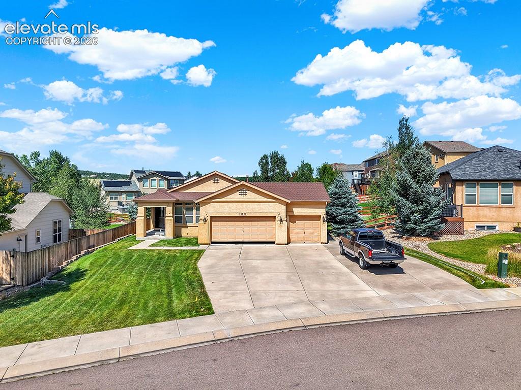 Image 40 of 40: Ranch-style residence featuring a prominent two-car garage, covered entry p