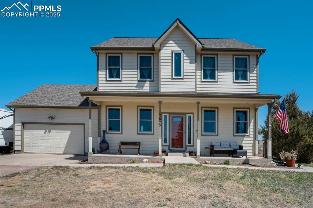 Image 2 of 50: View of front facade featuring an attached garage, and covered porch
