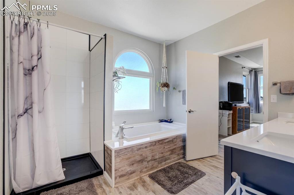 Image 24 of 50: Primary bathroom featuring shower and soaking tub with Fibo surround (no gr