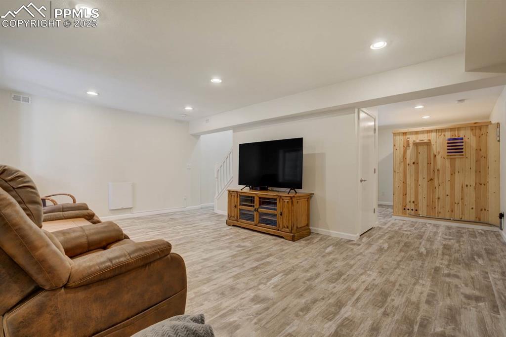 Image 32 of 50: Basement with family room and sauna
