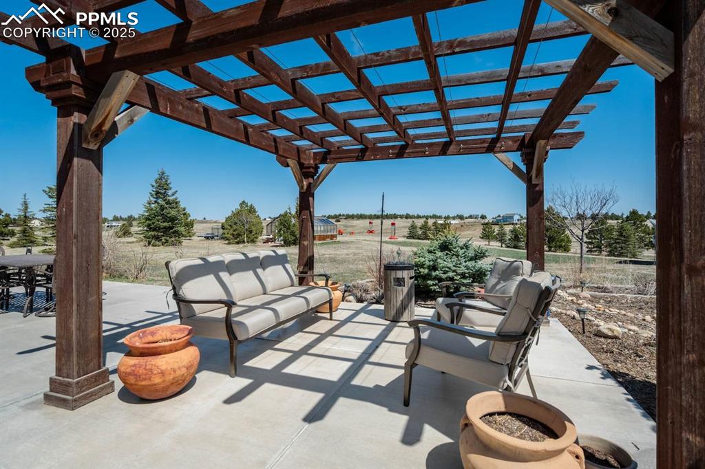 Image 36 of 50: Patio with a pergola (covers not pictured but included)