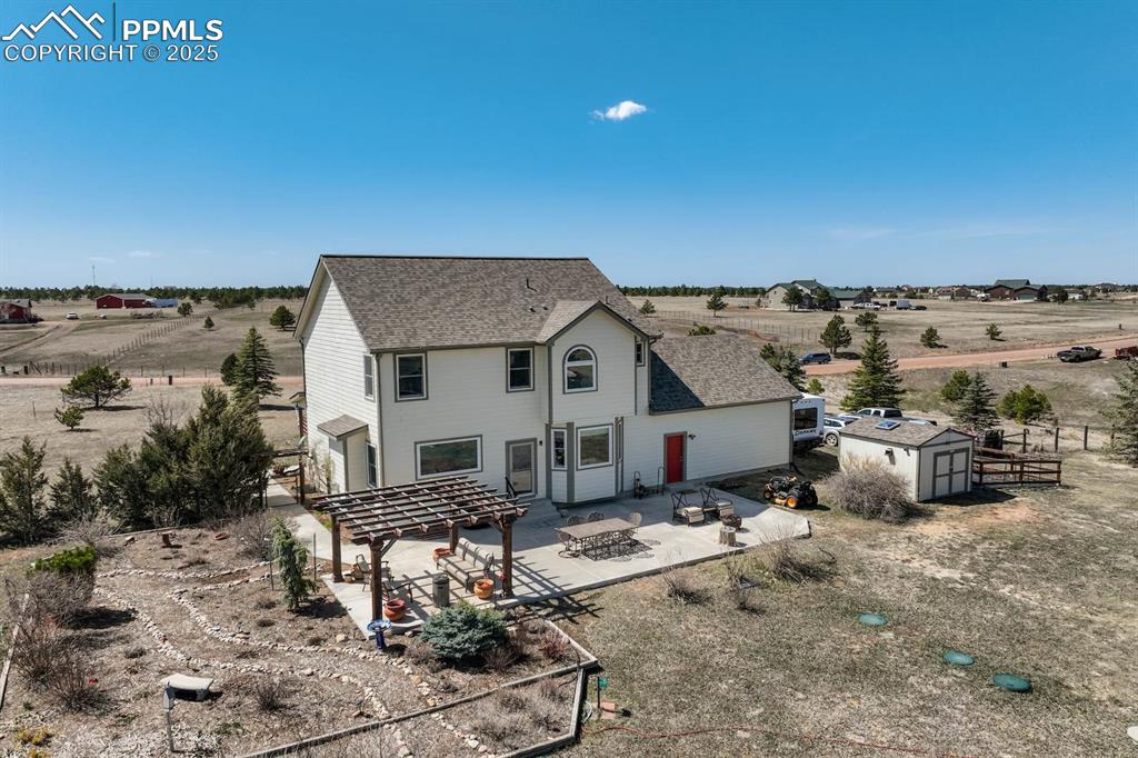 Image 42 of 50: Aerial view of back of house and garden area