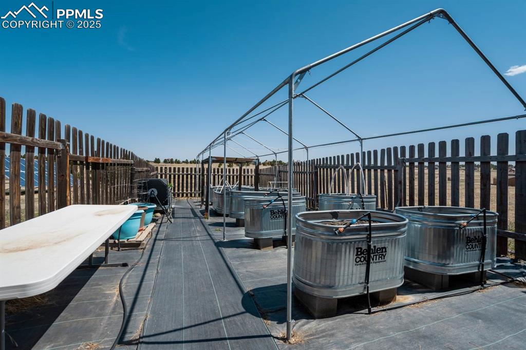 Image 45 of 50: Fenced in vegetable garden with 13 garden troughs (all irrigated)