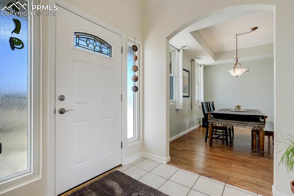 Image 5 of 50: Entrance foyer with tile floors, and a healthy amount of sunlight
