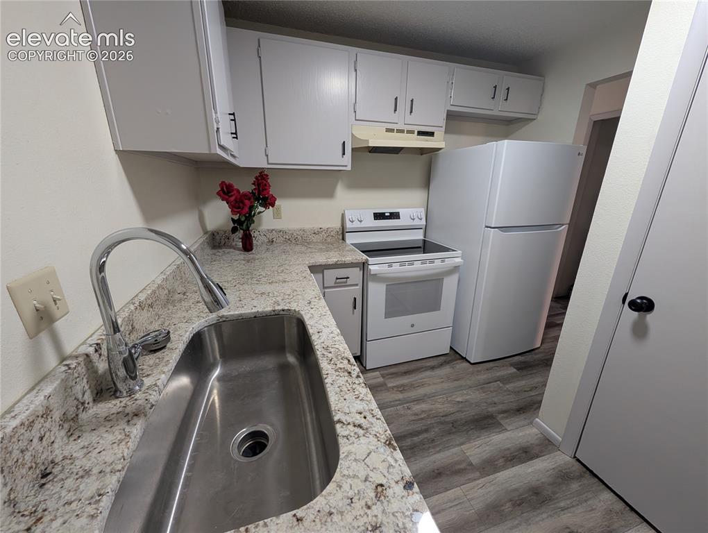 Image 19 of 33: Kitchen featuring a stainless steel sink, chrome gooseneck faucet, light gr