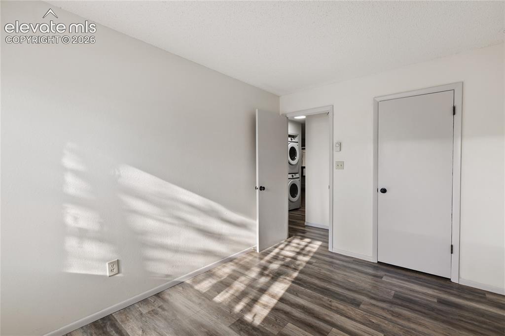 Image 24 of 33: Interior space featuring wood-finish flooring, white walls, and white trim