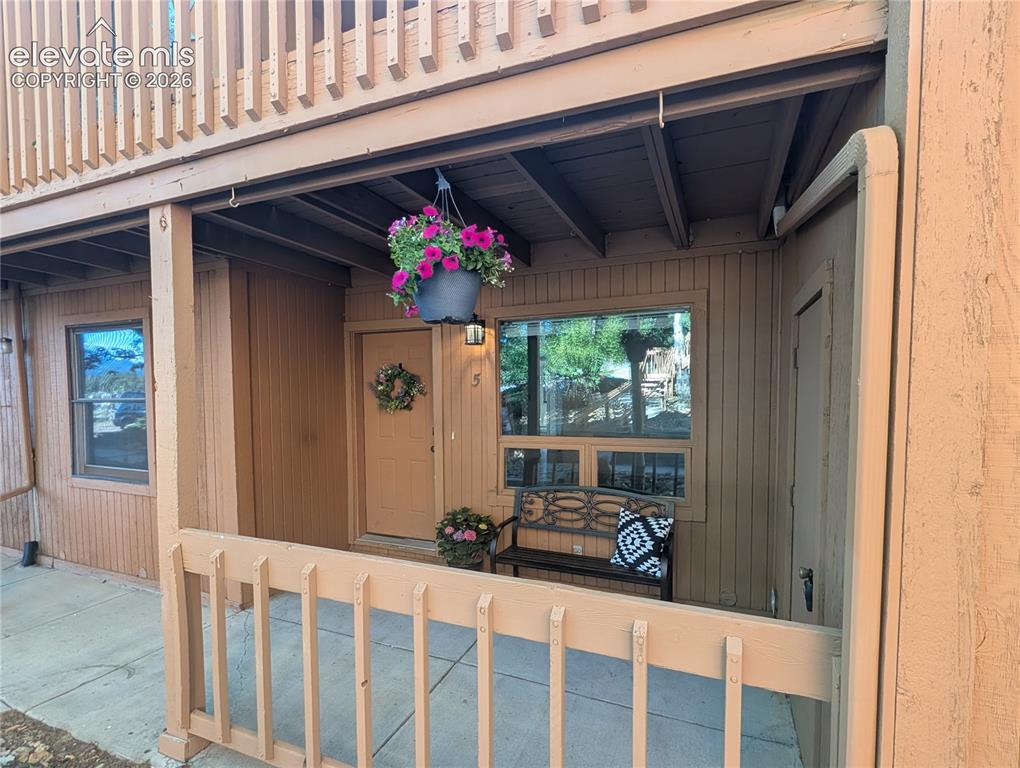 Image 3 of 33: Private entrance porch featuring wood siding, an exterior light fixture, an