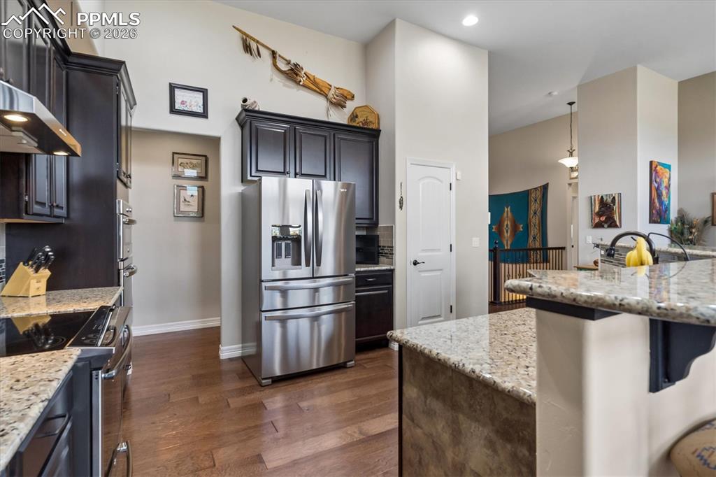 Image 10 of 48: Kitchen featuring ceiling fan, stainless steel appliances, a kitchen island