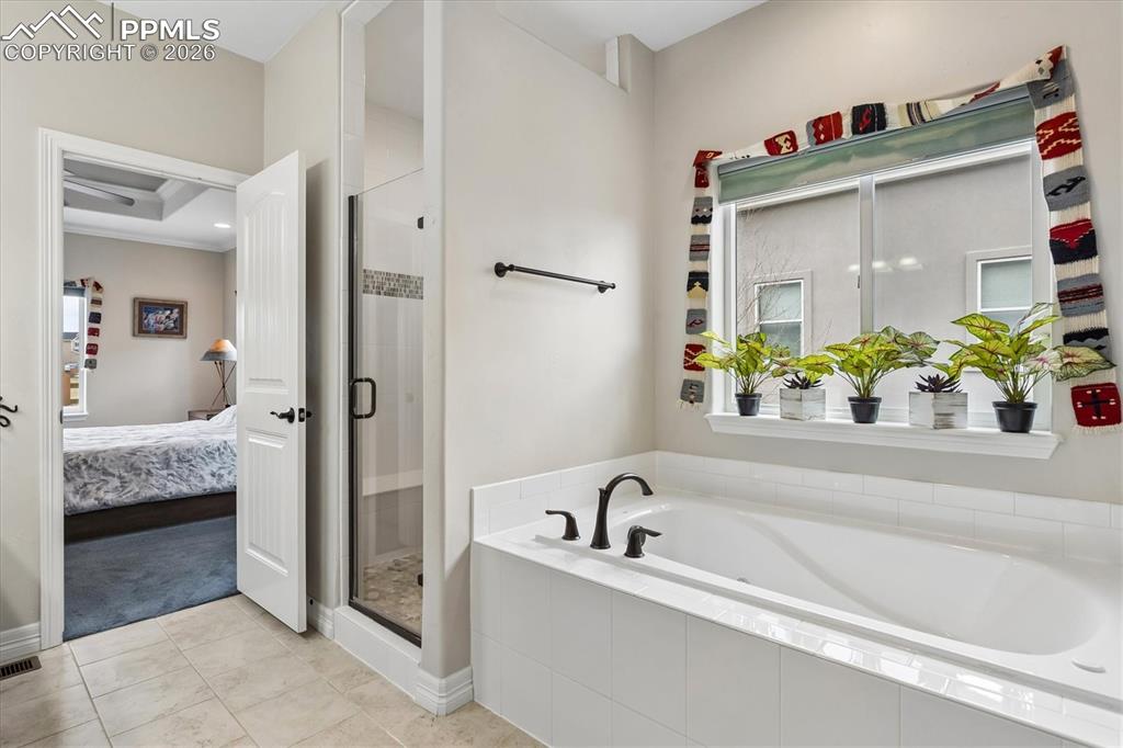 Image 21 of 48: Full bath with a shower stall, double vanity, and a spacious closet
