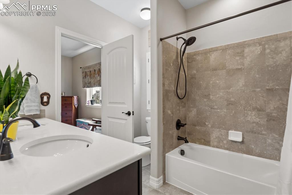 Image 28 of 48: Bedroom with light carpet and a ceiling fan