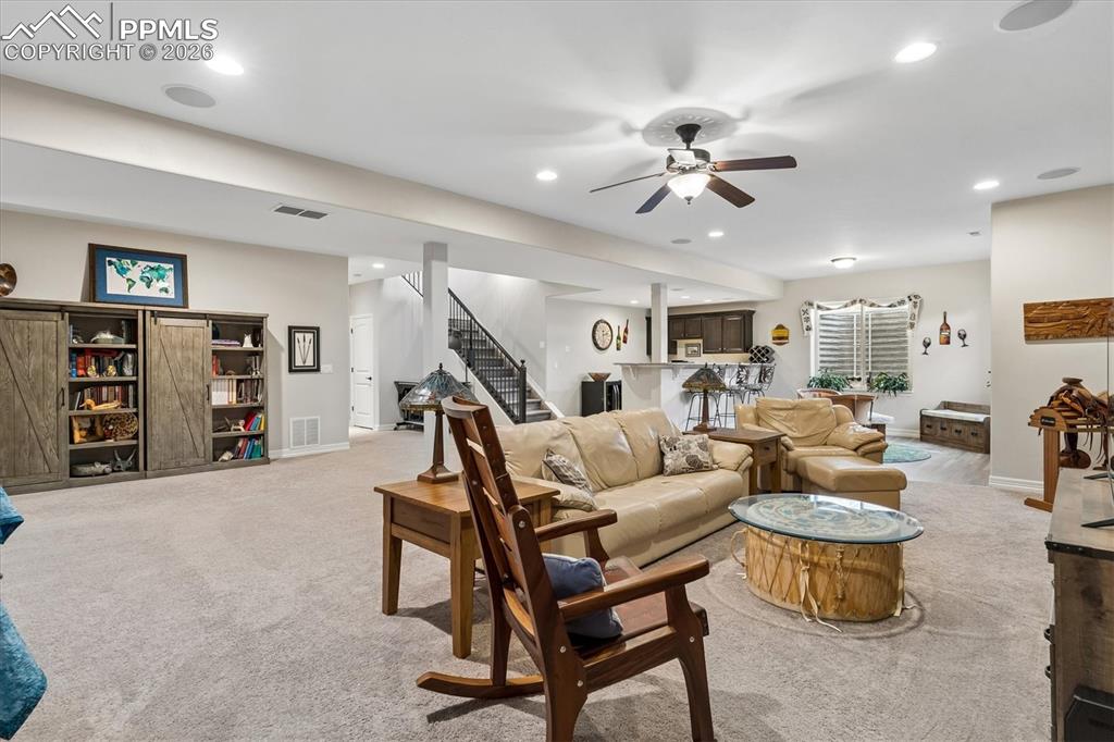 Image 31 of 48: Living room featuring light carpet, ceiling fan, and recessed lighting