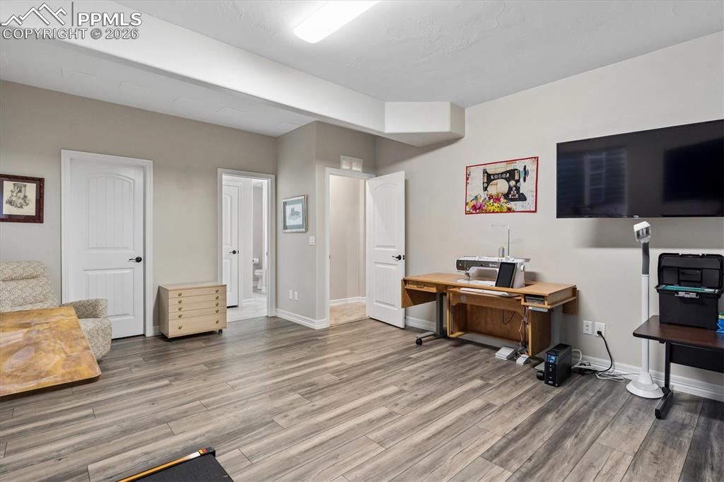 Image 39 of 48: Office area with light wood-style flooring