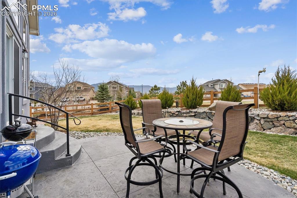 Image 43 of 48: View of patio featuring an outdoor fire pit, outdoor dining space, and a re