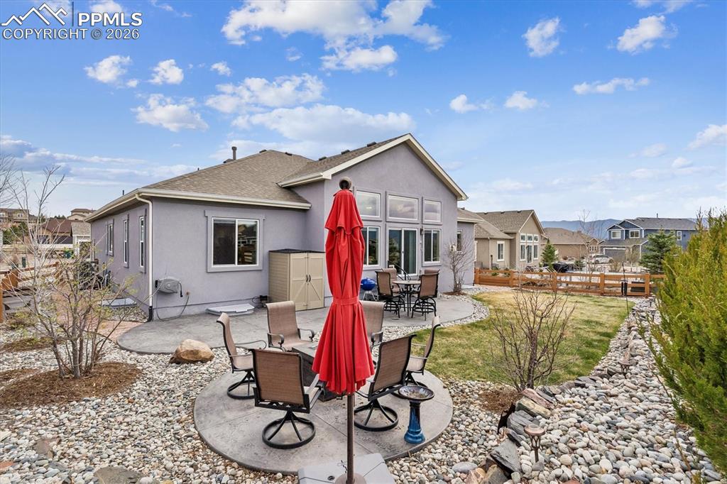 Image 44 of 48: View of patio / terrace with outdoor dining space and a residential view