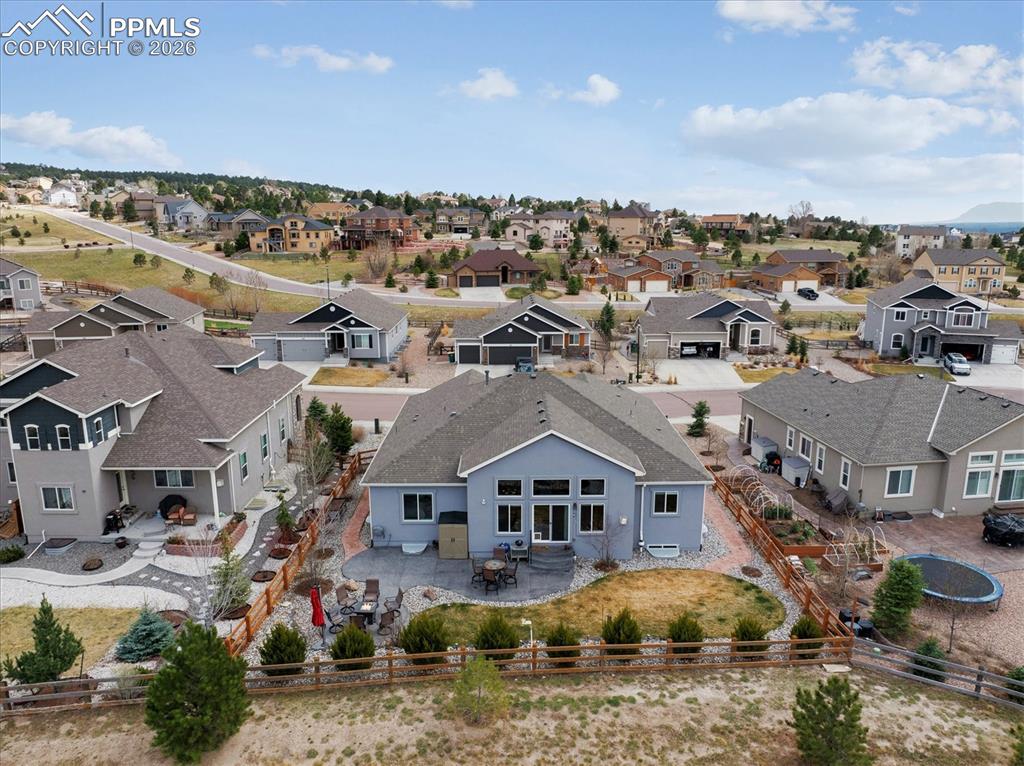 Image 45 of 48: Rear view of house with stucco siding, a patio area, roof with shingles, an