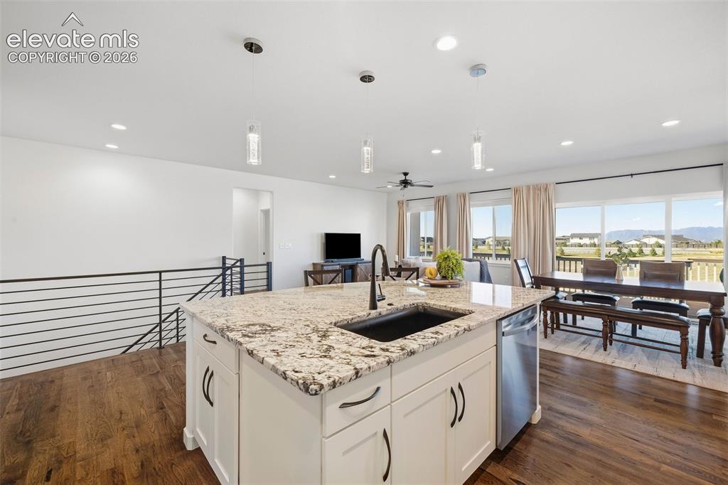 Image 11 of 46: The oversized island features storage AND seating and overlooks the dining