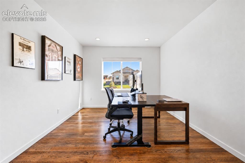 Image 14 of 46: This second main-floor bedroom is currently in use as an office. It has Fre