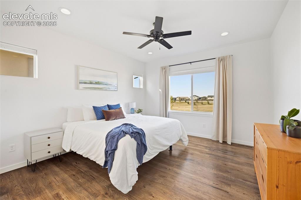 Image 16 of 46: Wake up to why you live here! The main-level primary bedroom has incredible