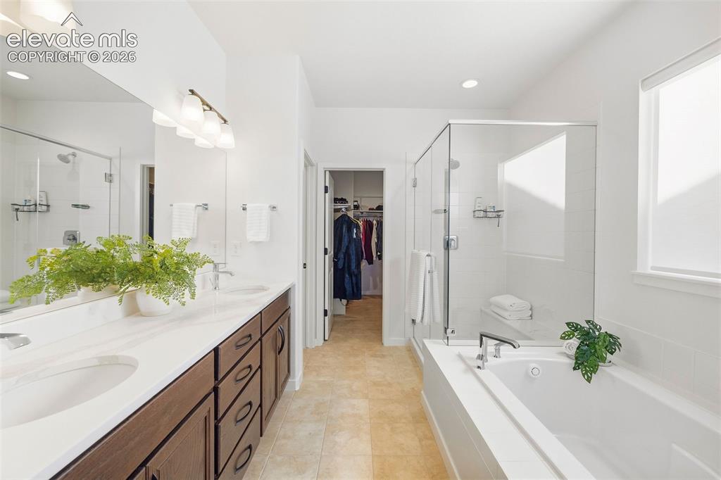 Image 19 of 46: The primary bath is a five-piece and offers a measure of calm to start and 