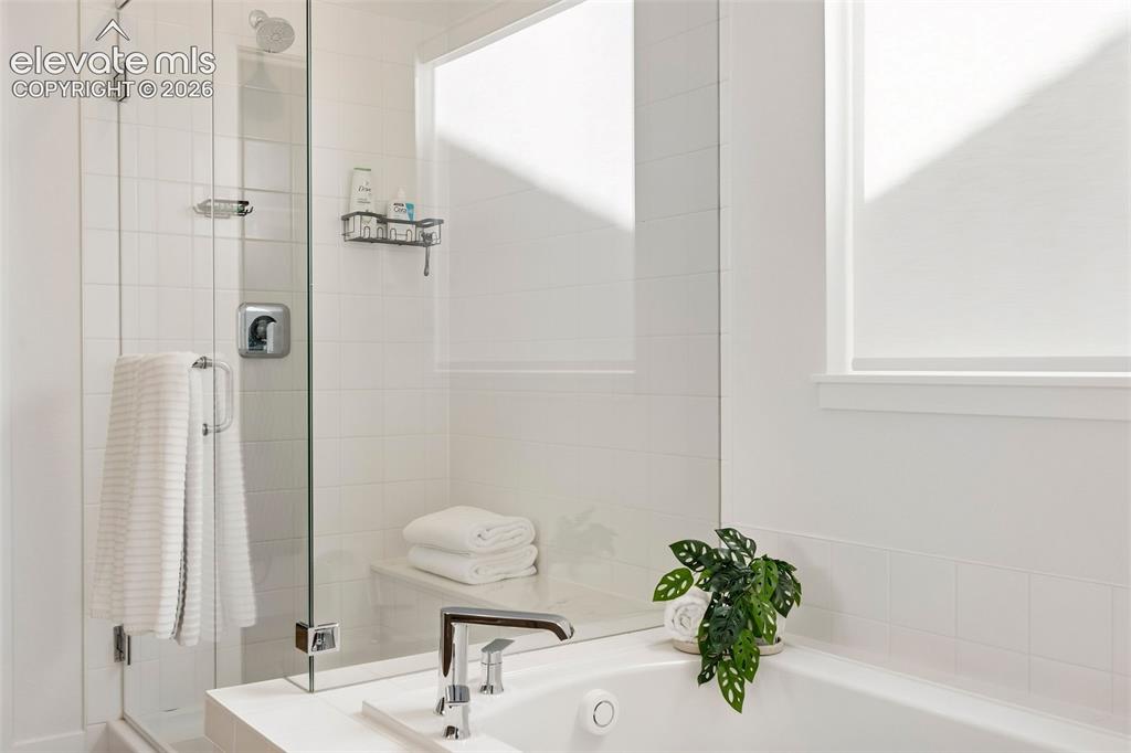 Image 21 of 46: Enjoy a luxurious bath in the oversized soaking tub, or a long, hot shower