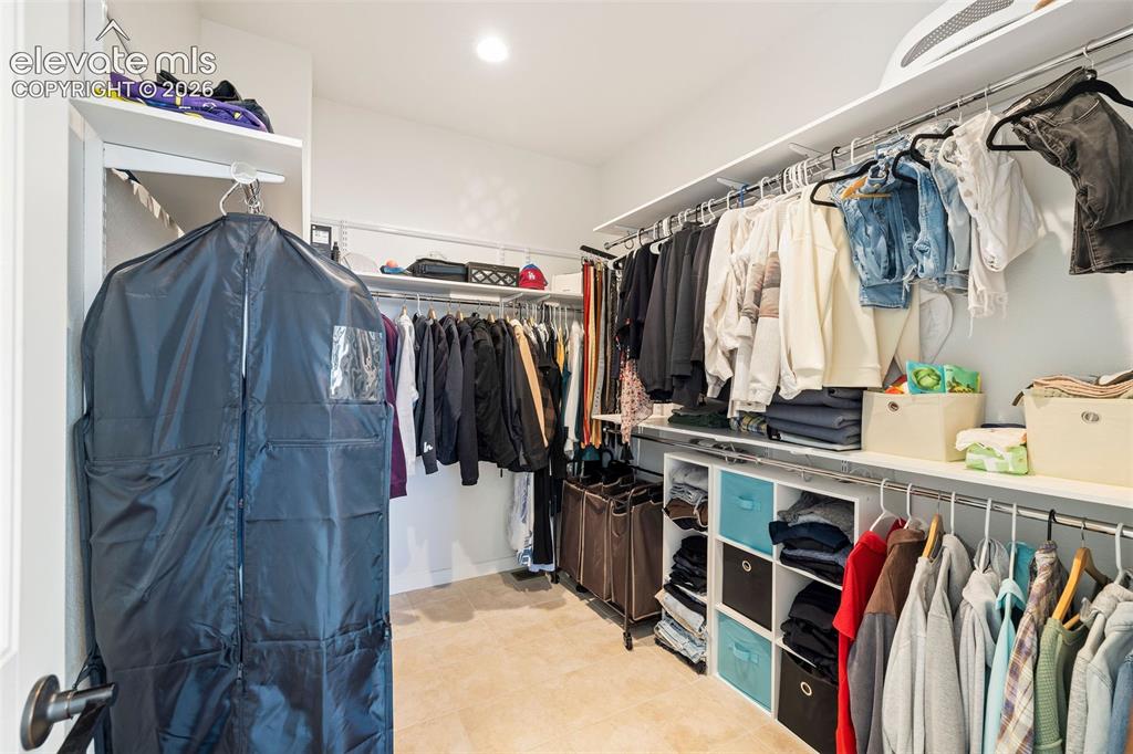 Image 22 of 46: No skimpy closets here: the primary walk-in closet has room for all your im