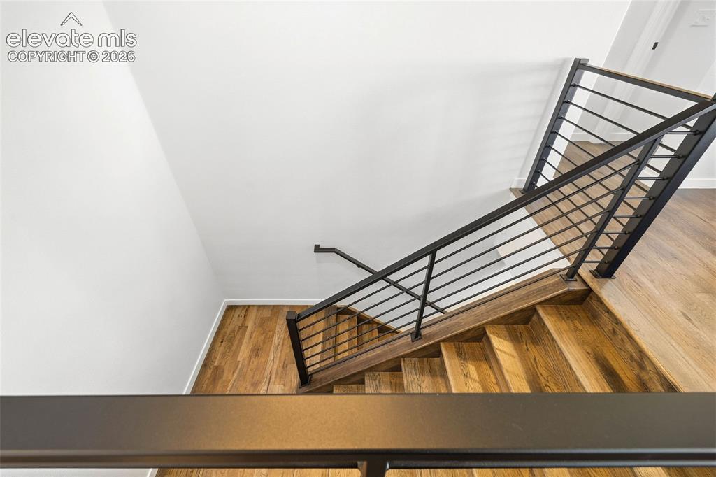 Image 25 of 46: The beautiful hardwood floors continue down the stairs to the basement leve