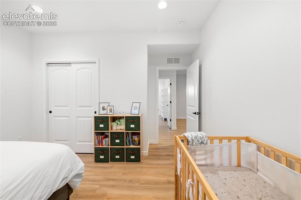 Image 30 of 46: The third bedroom has a double reach-in closet, recessed lighting and LVP f