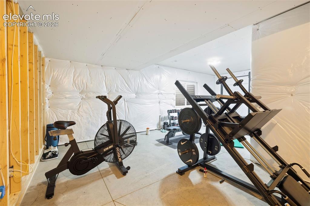 Image 32 of 46: The unfinished junior suite in the basement is currently being used as an e