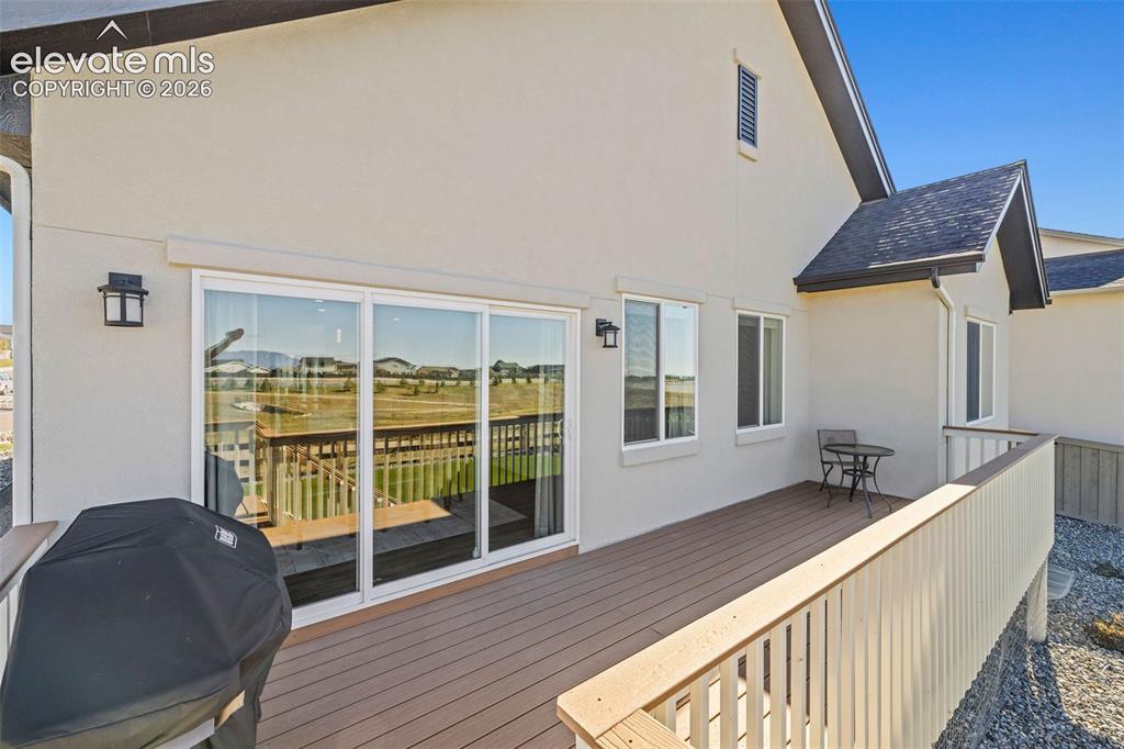 Image 34 of 46: The composite deck has stairs down to the back yard and easy access to the 