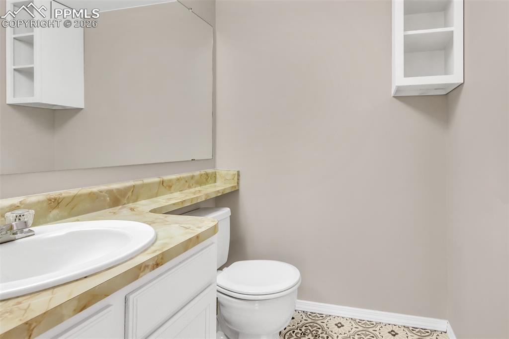 Image 12 of 30: Half bath featuring vanity and toilet