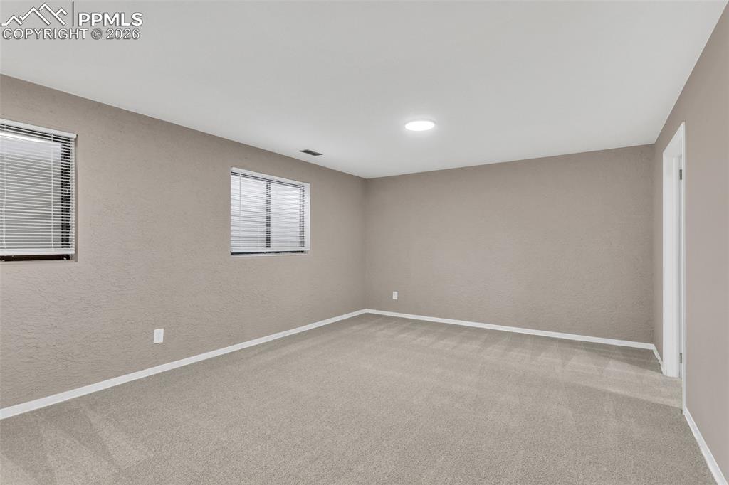 Image 14 of 30: Unfurnished room featuring light colored carpet and a textured wall