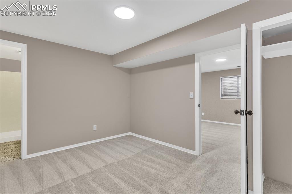 Image 17 of 30: Basement featuring light carpet and baseboards