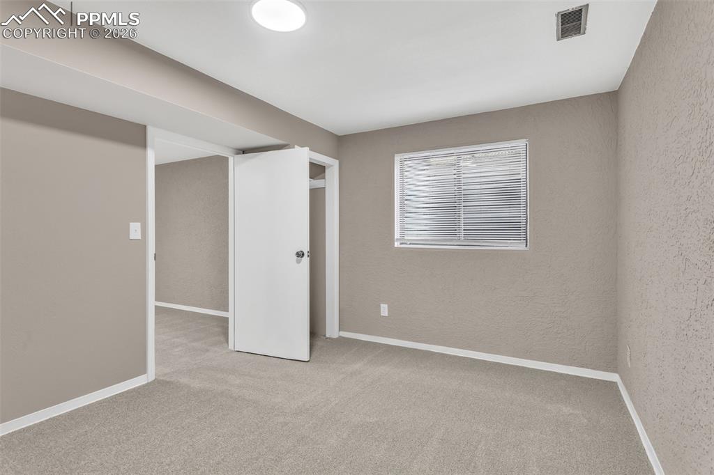 Image 18 of 30: Unfurnished bedroom featuring light carpet and baseboards