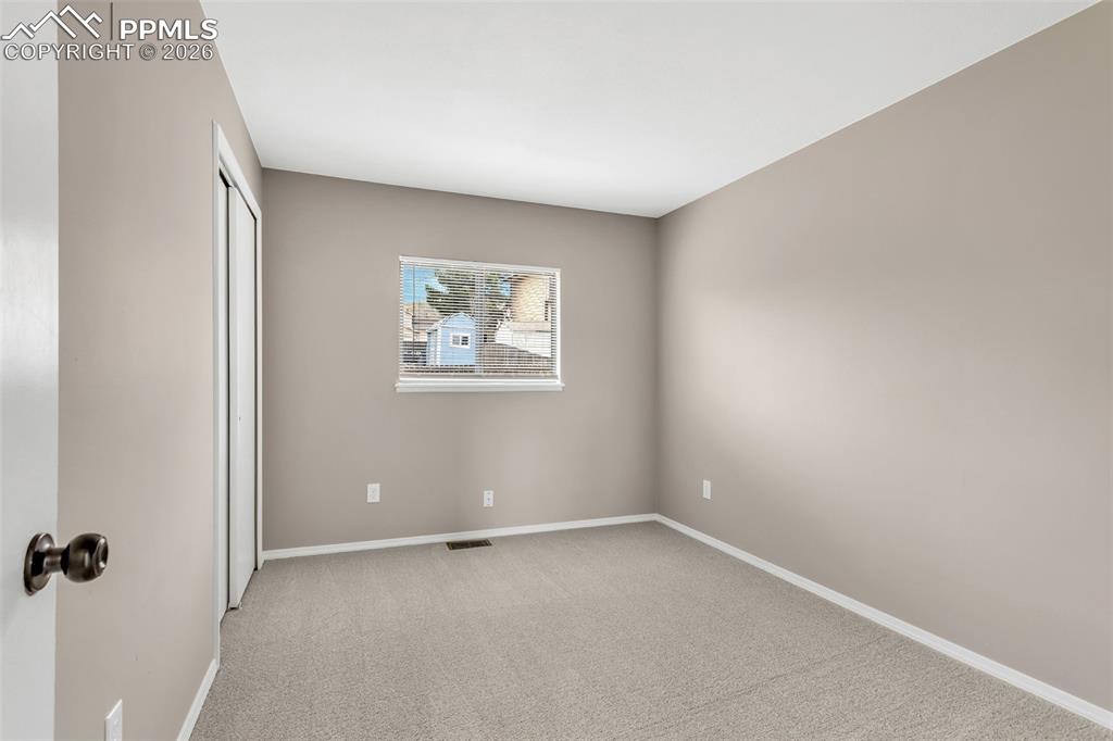 Image 21 of 30: Unfurnished bedroom featuring light colored carpet and a closet