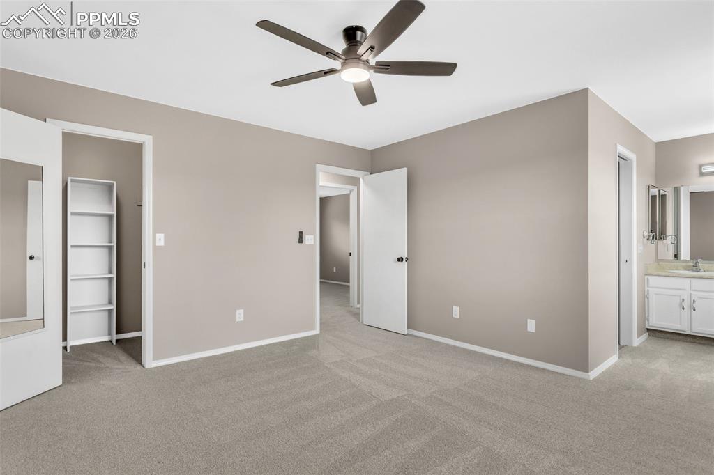 Image 23 of 30: Unfurnished bedroom featuring light carpet, connected bathroom, and a ceili