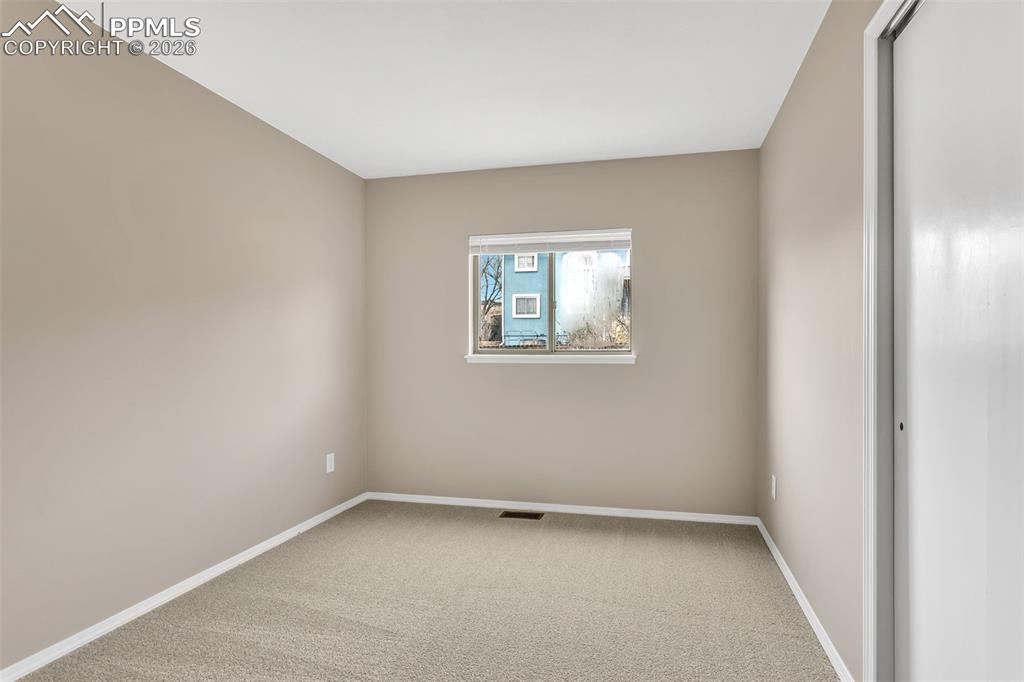 Image 26 of 30: Spare room with light carpet and baseboards