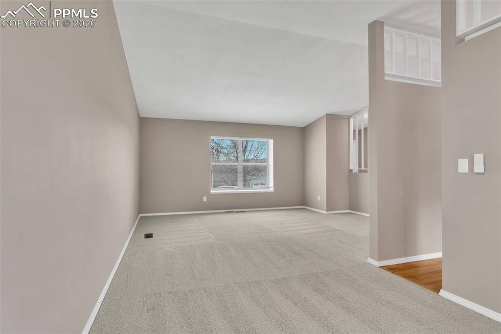 Image 4 of 30: Spare room featuring light carpet and baseboards