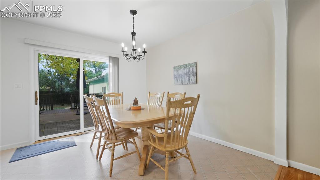Image 13 of 34: The Dining Room has a slider out to the backyard composite deck for outdoor