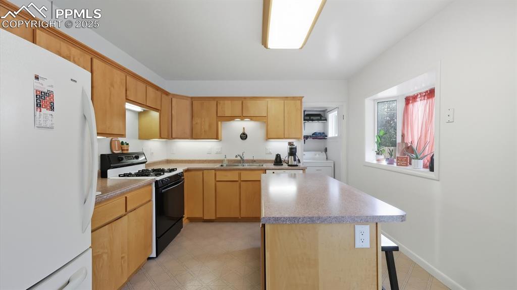 Image 18 of 34: Appliances include an electric range oven, dishwasher, and refrigerator.