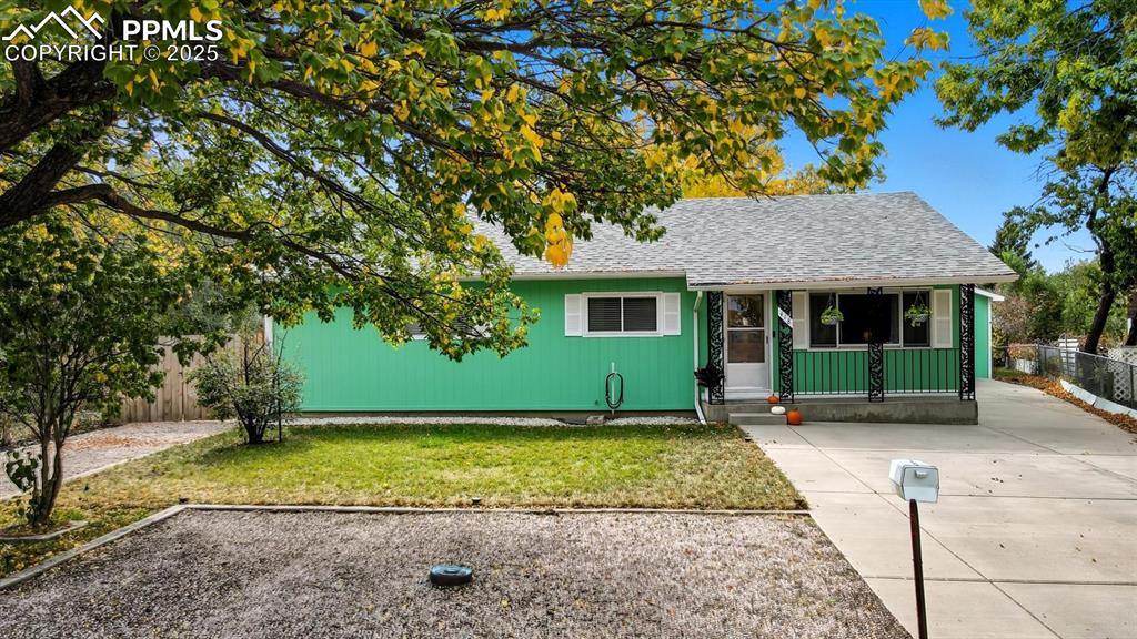 Image 2 of 34: Low maintenance landscaping with mature trees for shade and privacy.