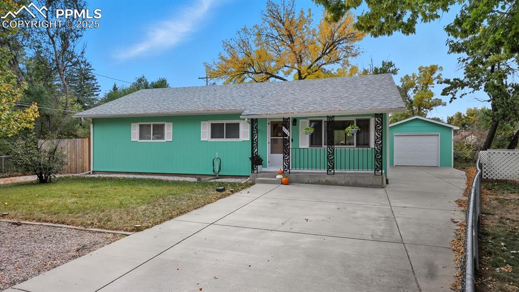 Image 5 of 34: Extended concrete driveway with oversized, single, detached garage.