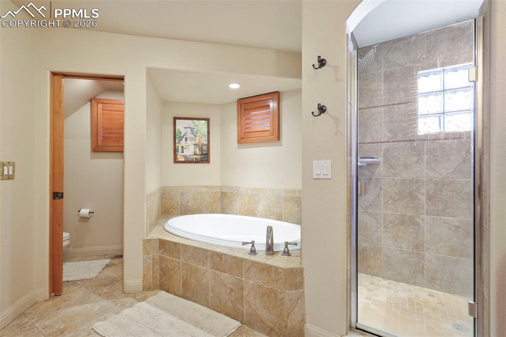 Image 12 of 27: Primary suite with attached 5 piece bathroom, walk-in closet. 