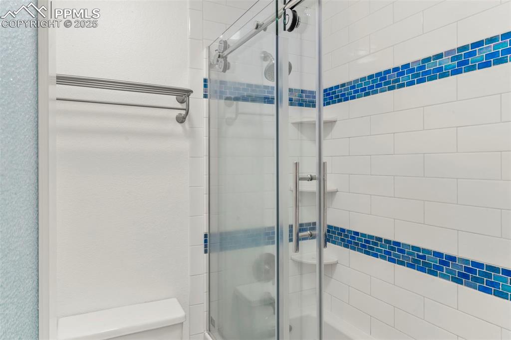 Image 14 of 26: Tiled Shower / Tub Combo in the Owner’s Suite