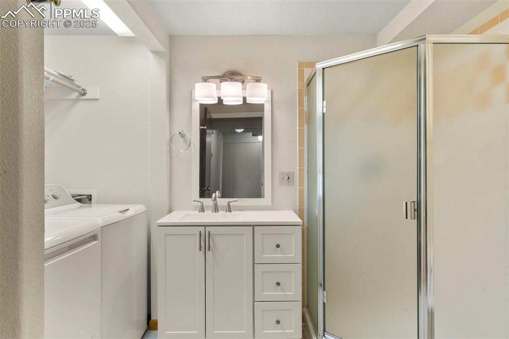 Image 20 of 26: Guest Bathroom and Laundry Area in the Lower Level