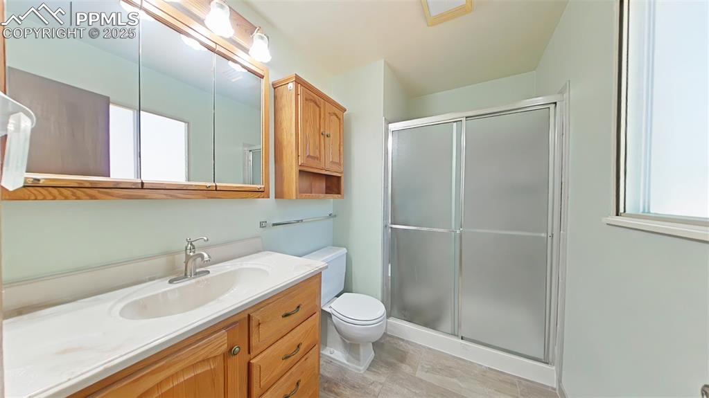 Image 16 of 25: Primary 3/4 bathroom featuring vanity, a shower stall.