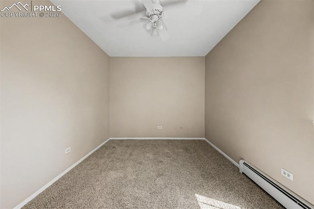 Image 12 of 42: Neutral-toned walls complement the textured carpet flooring