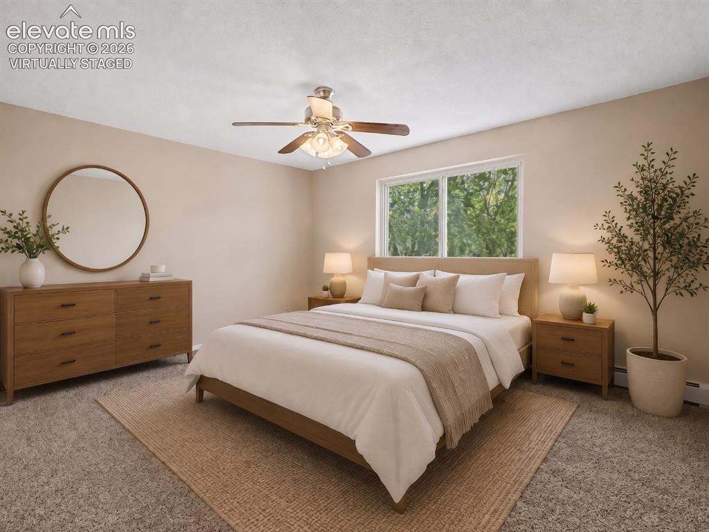 Image 13 of 50: virtually staged Carpeted bedroom featuring a large window, a ceiling fan w