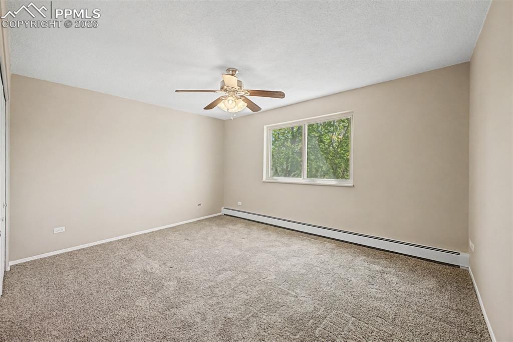 Image 15 of 42: Neutral-toned carpeted room with light beige walls